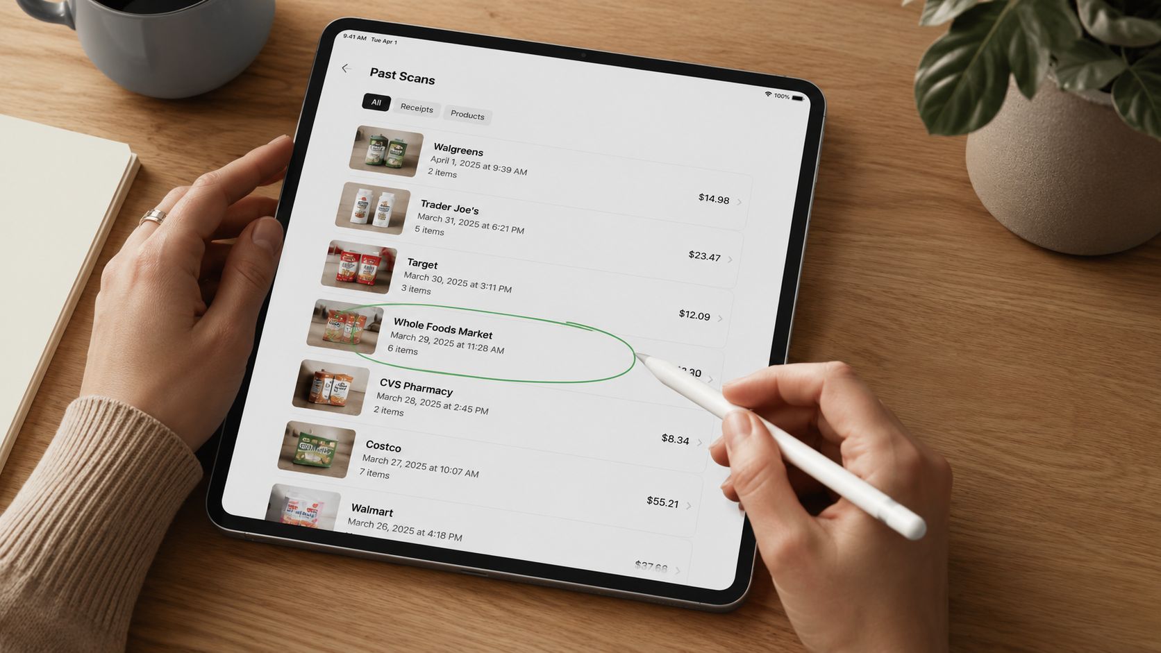 A person using an Apple Pencil on an iPad screen showing a list of shopping store receipts.